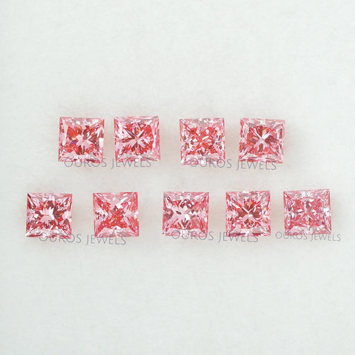 front view of loose pink princess cut diamonds lab grown on fabric