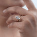 old mine moval cut diamond double prong engagement ring in model's hand