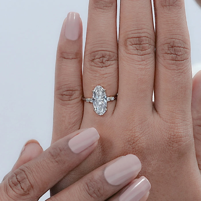 moval cut lab grown diamond solitaire accent engagement ring in finger