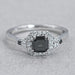 top view of asscher cut black diamond halo engagement ring on grey background
