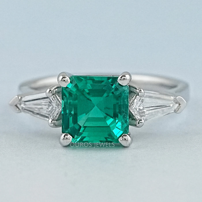 front view of asscher cut green gemstone with bullet diamond 3 stone wedding ring