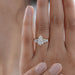 pear and baguette cut lab diamond five stone engagement ring in finger