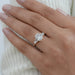 elongated cushion and baguette cut diamond five stone wedding ring on model's finger