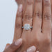 asscher cut lab diamond halo engagement ring on model's finger