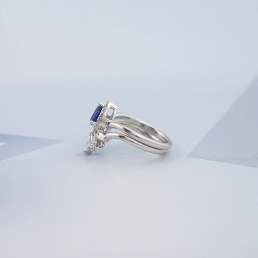 left view of sapphire pear gemstone with marquise diamond carved wedding band