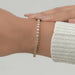 cushion cut lab created diamonds bezel set tennis bracelet in yellow gold on hand