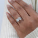 pear and cushion-cut diamond hidden halo toi et moi engagement ring in finger