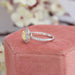 side view of yellow cushion cut diamond double halo wedding ring on jewelry box