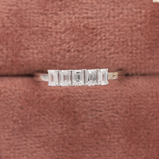 emerald-cut lab diamond five-stone wedding ring with white gold band in jewelry box