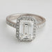 emerald cut lab diamond halo engagement ring's front angle view on grey fabric