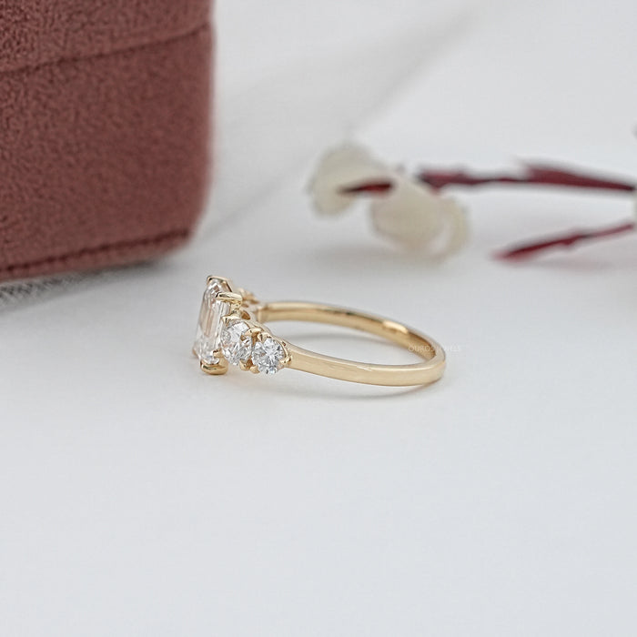 side view of emerald cut and round lab diamond five stone engagement ring