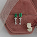 emerald gemstone drop earrings with princess and pear diamonds