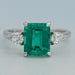 front view of green emerald gemstone pear diamond three stone engagement ring