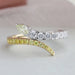 front view of pear and round-cut lab diamond bypass colored wedding band