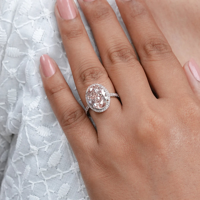 fancy pink oval cut lab diamond halo engagement ring in finger