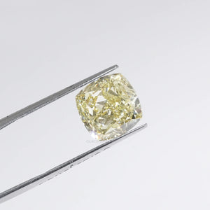 Fancy Yellow Cushion Cut Diamond in a Tweezer 