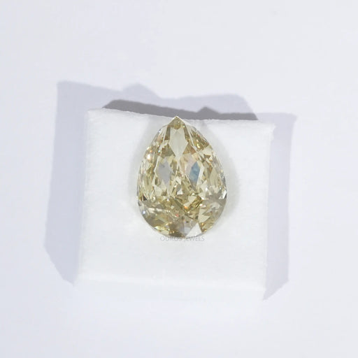 modified yellow loose pear shaped diamond lab grown on white surface