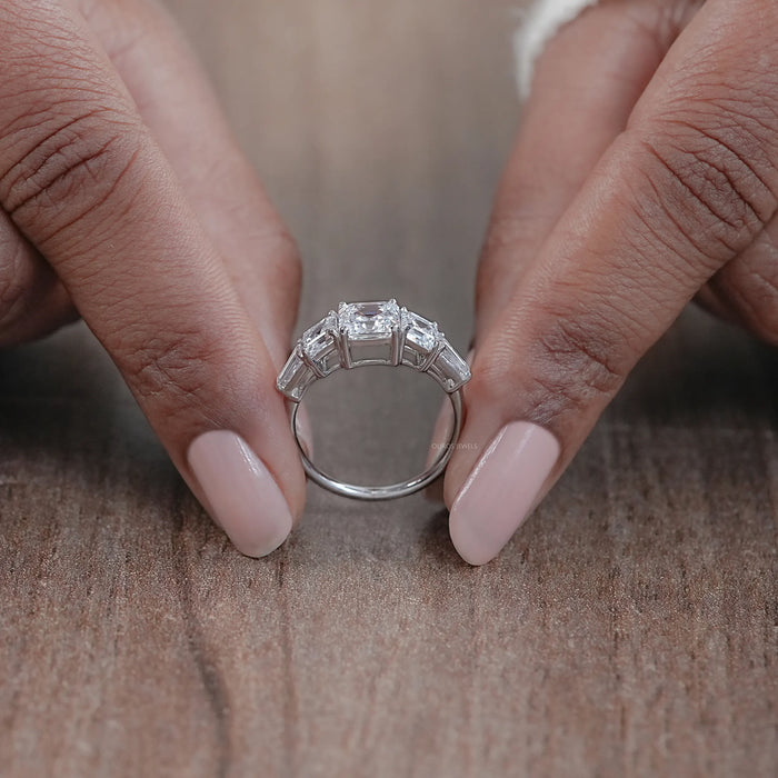 close view of asscher cut diamond five stone engagement ring with white gold band