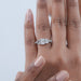 radiant cut diamond five stone engagement ring with white gold band in finger