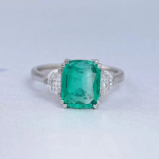 front view of green cushion and half moon cut lab diamond three stone engagement ring