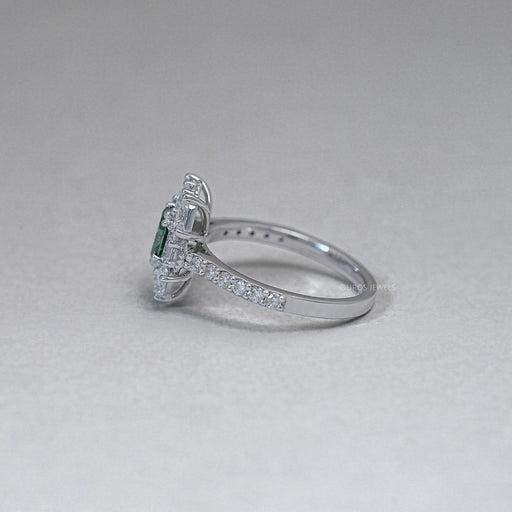 side view of green oval cut diamond half moon halo engagement ring