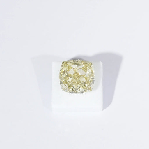 igi certified yellow modified cushion cut man made diamond on white surface