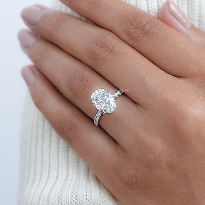 oval cut lab grown diamond hidden halo solitaire engagement ring in finger