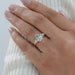 pear and baguette cut lab diamond five stone engagement ring on model's finger