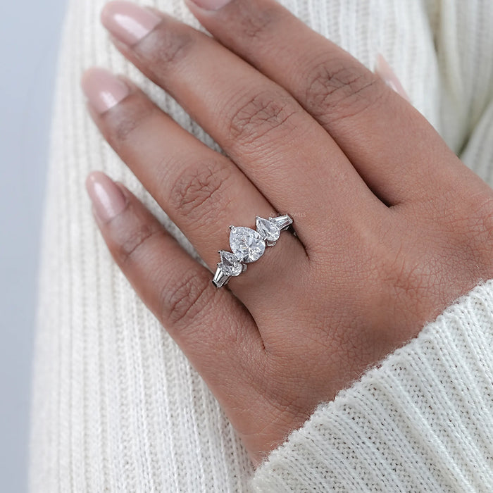 pear cut diamond five stone engagement ring in white gold band on model's finger