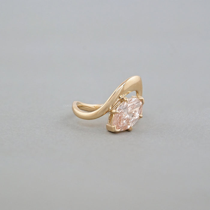 side view of pink marquise cut diamond bypass engagement ring yellow gold band