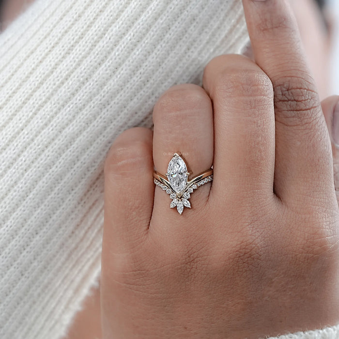 marquise-cut lab diamond wedding ring set with yellow gold band on model's finger
