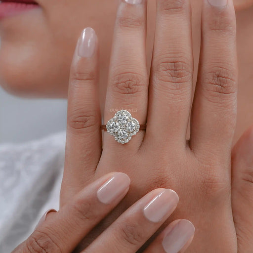 round cut lab diamond flower shape halo anniversary ring on model's finger