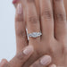 asscher cut diamond five stone engagement ring with white gold band in finger