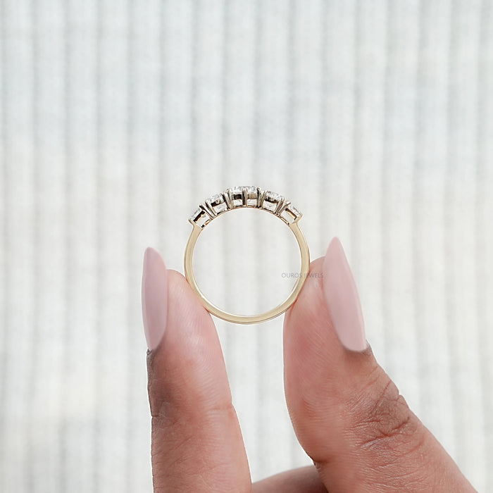 close view of round and shield cut lab diamond five stone engagement ring