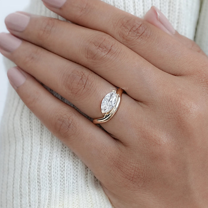 marquise cut lab diamond wave engagement ring in yellow gold wear in finger