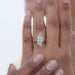 top view of marquise diamond bezel set split shank band engagement ring in finger