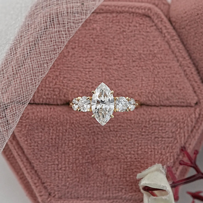 marquise and round cut lab diamond five stone engagement ring in jewelry box