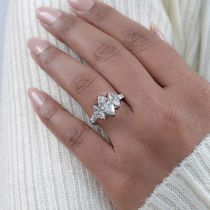 marquise cut diamond 5 stone engagement ring with white gold band on model's finger