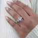 marquise cut diamond 5 stone engagement ring with white gold band on model's finger
