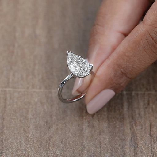 side front view of pear cut lab diamond solitaire engagement ring