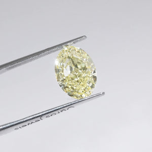 Yellow Oval Cut Diamond in a Tweezer 