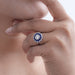 old european round diamond sapphire halo engagement ring on model's hand