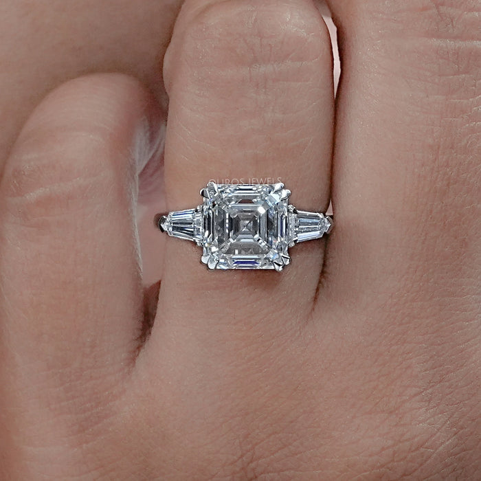 asscher cut lab diamond double prong three stone engagement ring's front view on finger