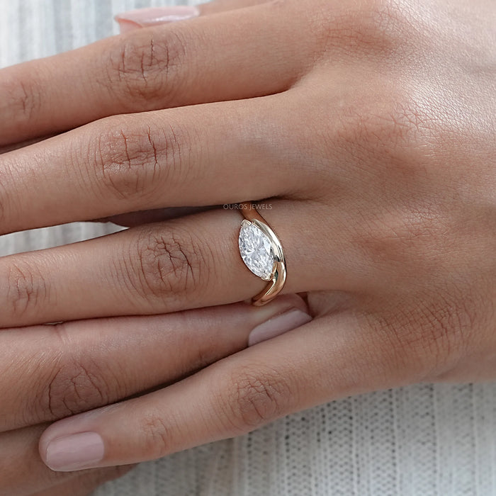 marquise cut lab diamond wave engagement ring in yellow gold worn in finger view