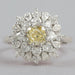 top view of fancy yellow cushion cut diamond with heart & pear sunburst halo ring