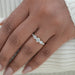 round and baguette diamond half bezel five stone engagement ring on model's finger
