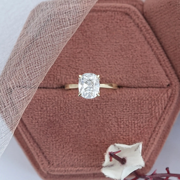 old mine cushion cut lab diamond petal solitaire engagement ring in jewelry box