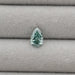 1.62 Carat Fancy Vivid Green Pear Cut Lab Grown Diamond displayed on a light grey fabric background.
