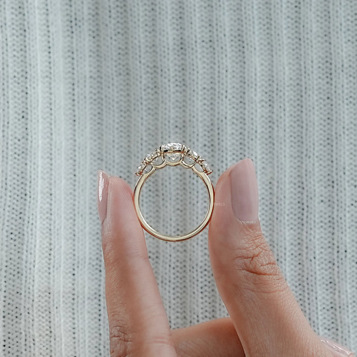 close view of oval and round cut lab diamond five stone engagement ring