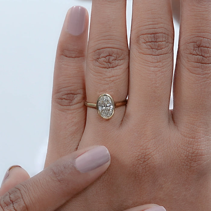 oval cut lab diamond hidden halo bezel set engagement ring on model's hand